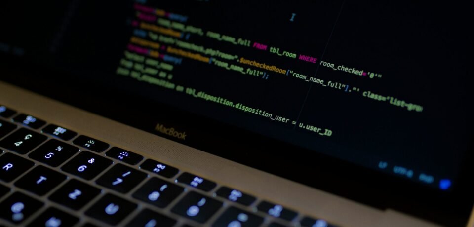 MacBook Pro with images of computer language codes
