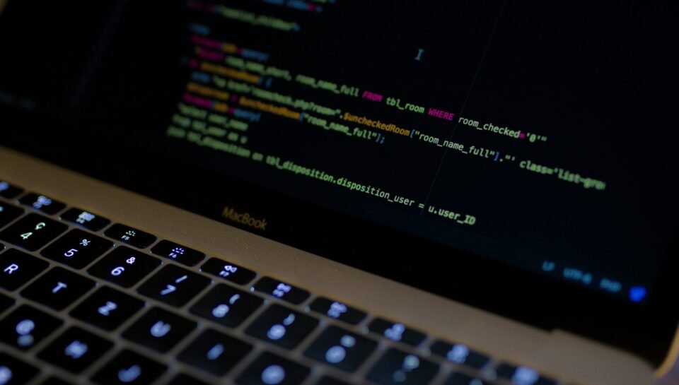 MacBook Pro with images of computer language codes