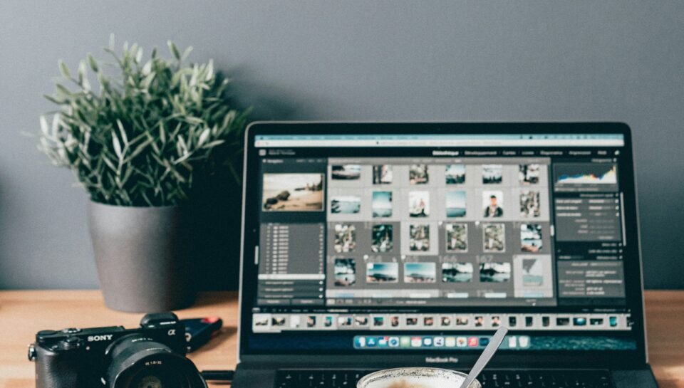 black laptop computer beside white ceramic mug on brown wooden table