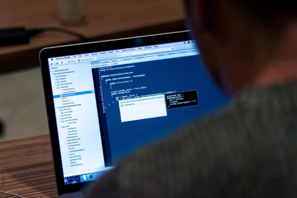 Programmer writing code laptop, location