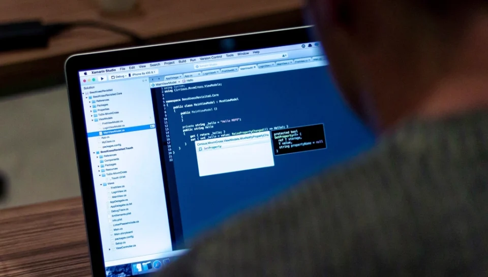 Programmer writing code laptop, location