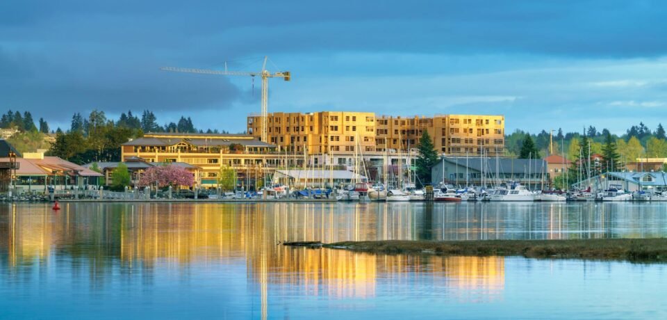 blue and yellow image of waterfront with boats and construction site