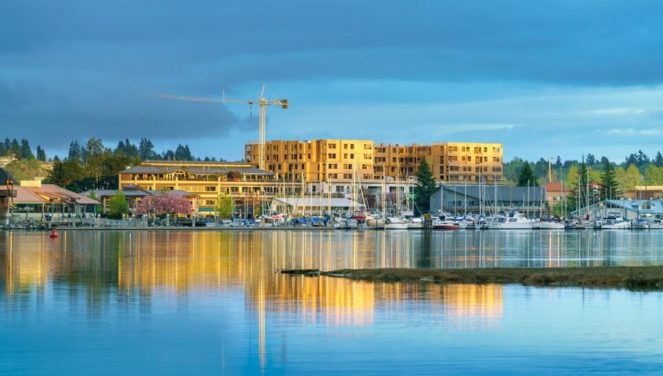 blue and yellow image of waterfront with boats and construction site